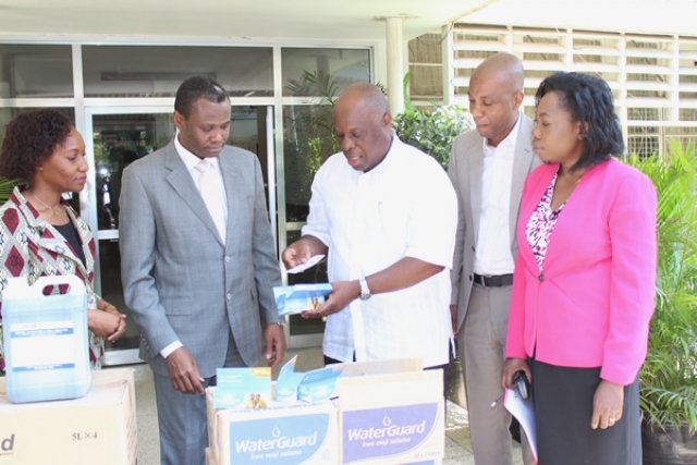 The WHO Representative, Dr. Rufaro Chatora hands over to the Permanent Secretary one of the water treatment tablets