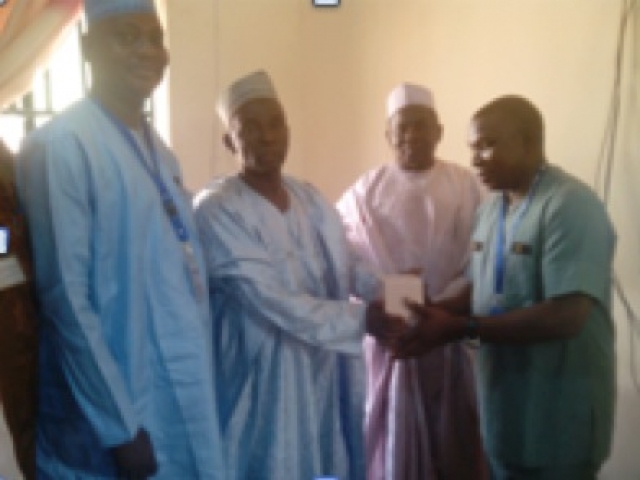 WHO State coordinator presenting oily chloramphenicol to the Kebbi State Commissioner of Health.