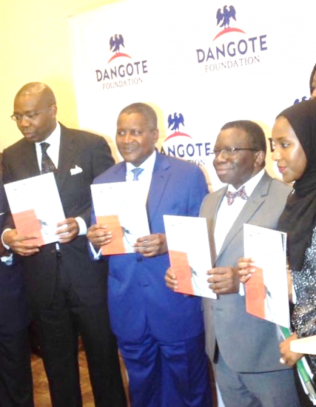 L-R Alhaji Aliko Dangote Professor Isaac Adewole and Halima Dangote during unveiling of the document