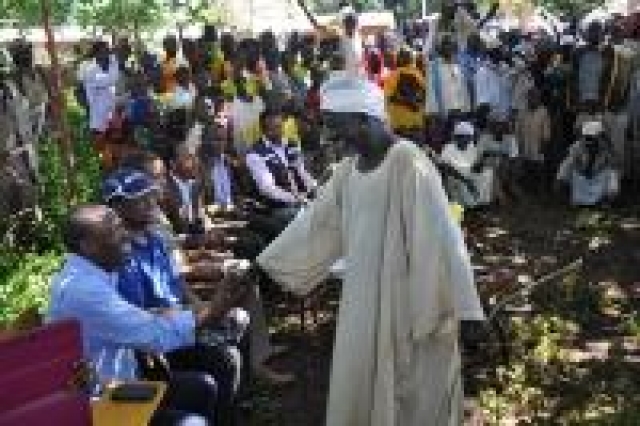 One of the community elders making a round of greetings. Dr Jean-Baptiste Roungou pictured in a hand-shake with the elder.