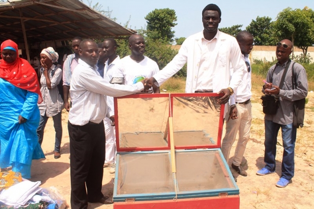 Deputy Director Health Promotion  handing-over locally produced solar cookers to the OIC of the psychiactric hospital