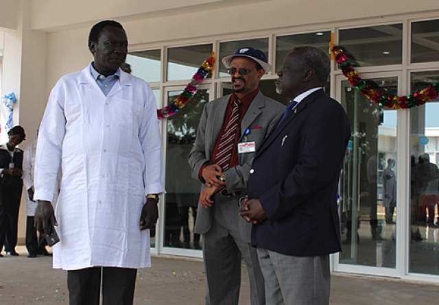 Hon Minister of Health Dr Riek Gai Kok, Dr Abdi Mohamed and Dr Makur Kariom, Undersecretary Ministry of Health at the Rumbek Maternity Hospital entrance