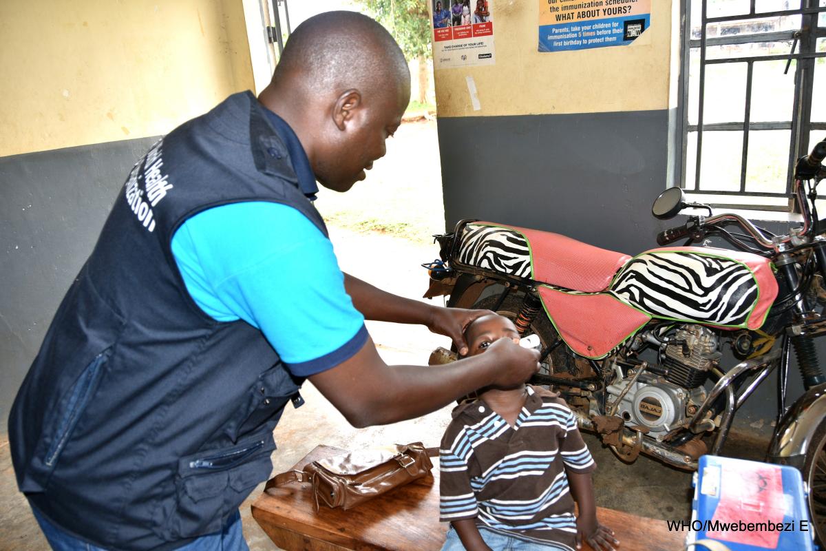 WHO Staff Dr. Tenywa immunizes a child at Namutumba Health Center III