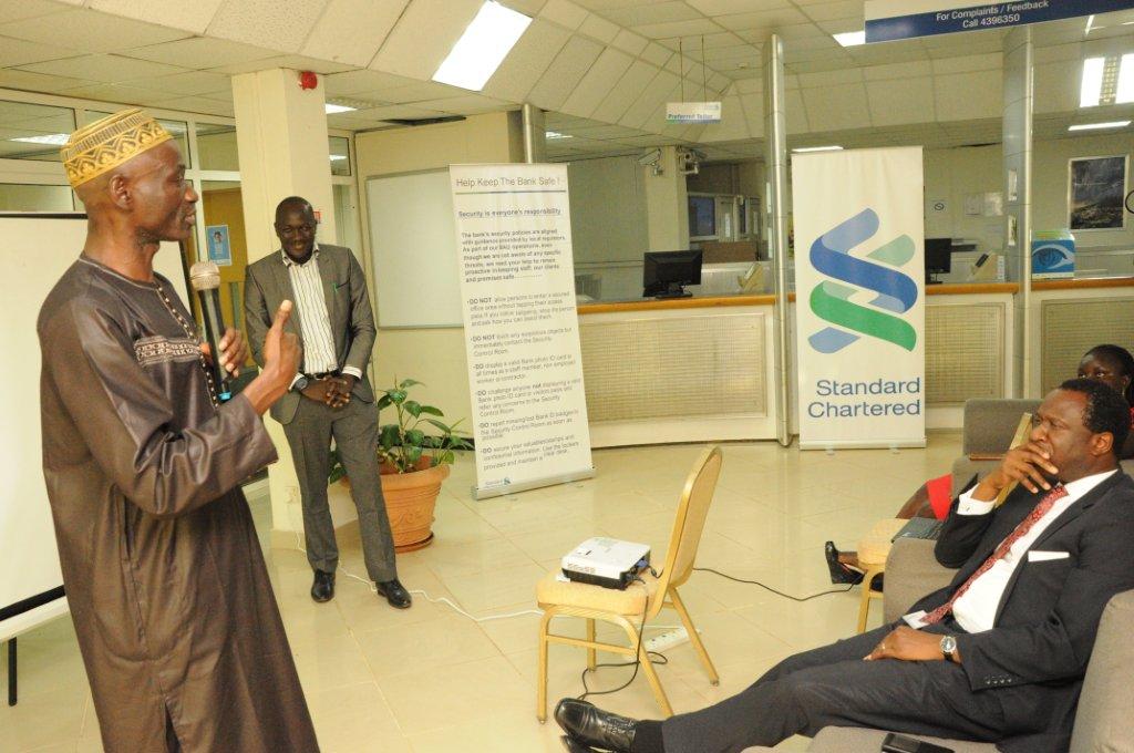 Mr Momodou Gassama (WHO) presenting on stress management in            workplaces for officials of Standard Chartered Bank  Gambia Ltd.