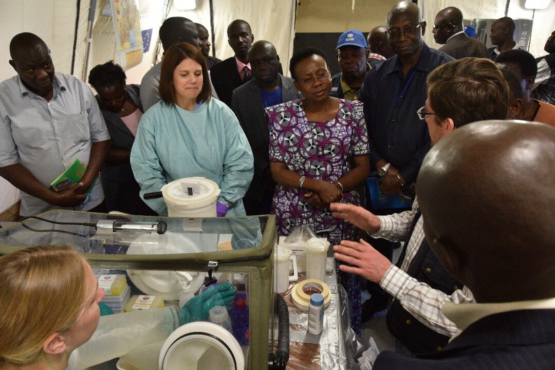 The Minister of Health Dr Aceng (Purple outfit) and the WHO representative Dr Jack Abdoulie (black outfit) listen to Dr Thomas Strecker from WHO during the commissioning of the mobile laboratory at Kapchorwa District Hospital 