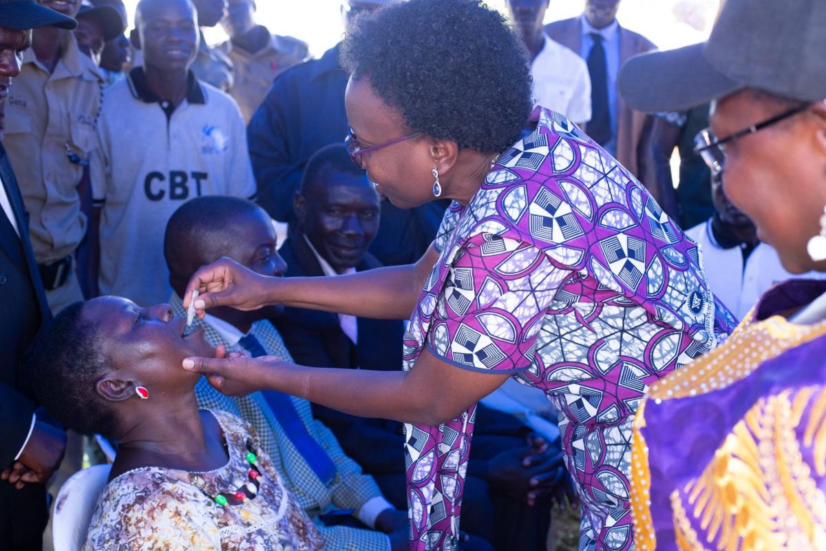 Minister of Health Dr Jane Ruth Aceng vaccinates a member of the community at the launch 