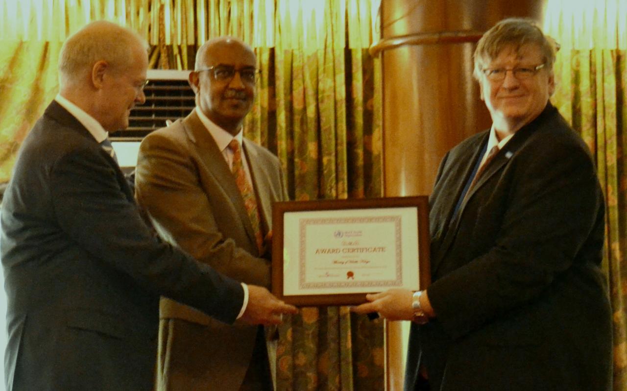 Dr Rudi Eggers, right, WHO Kenya Representative and Dr Werner Schultink, UNICEF Representative, hand over the MNTE certificate to Dr Rashid Aman, Chief Administration Secretary, MOH, Kenya