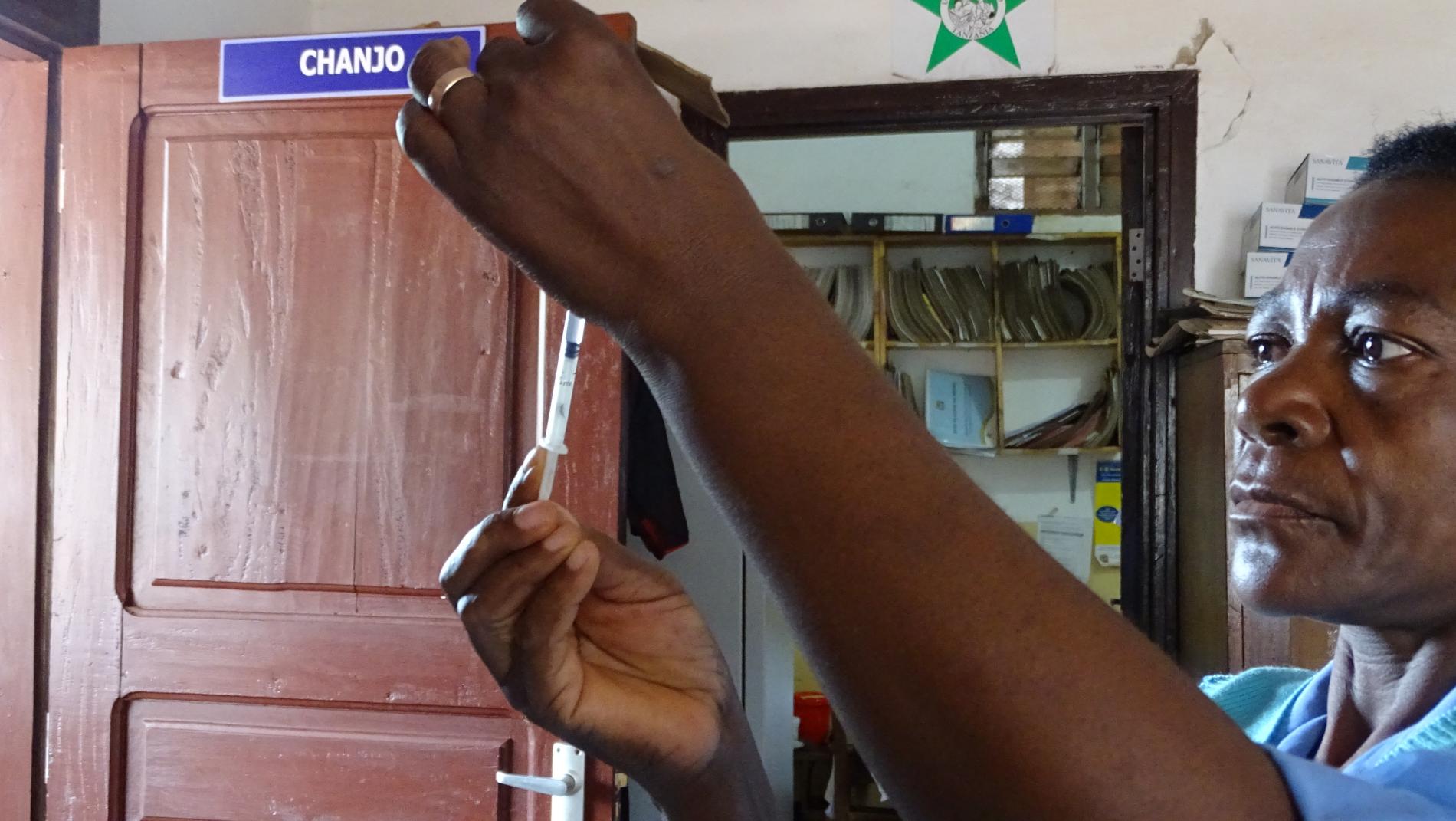 A health worker preparing a vaccine injection