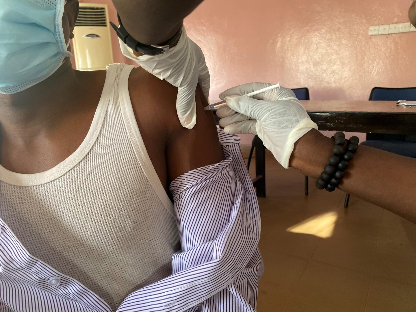 A health worker receiving their first dose on day one of the vaccination