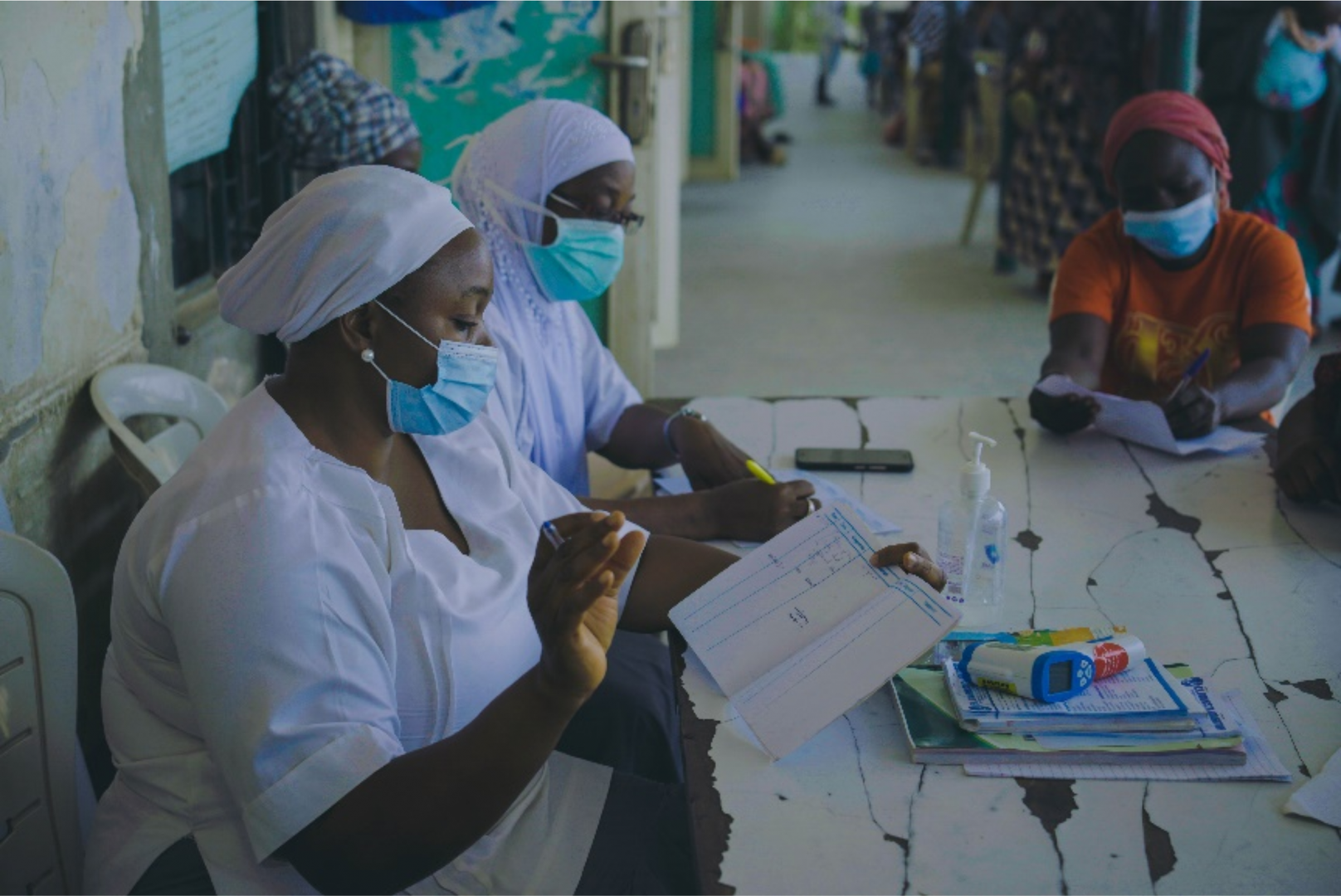 Health workers attending to a female patient in a health facility