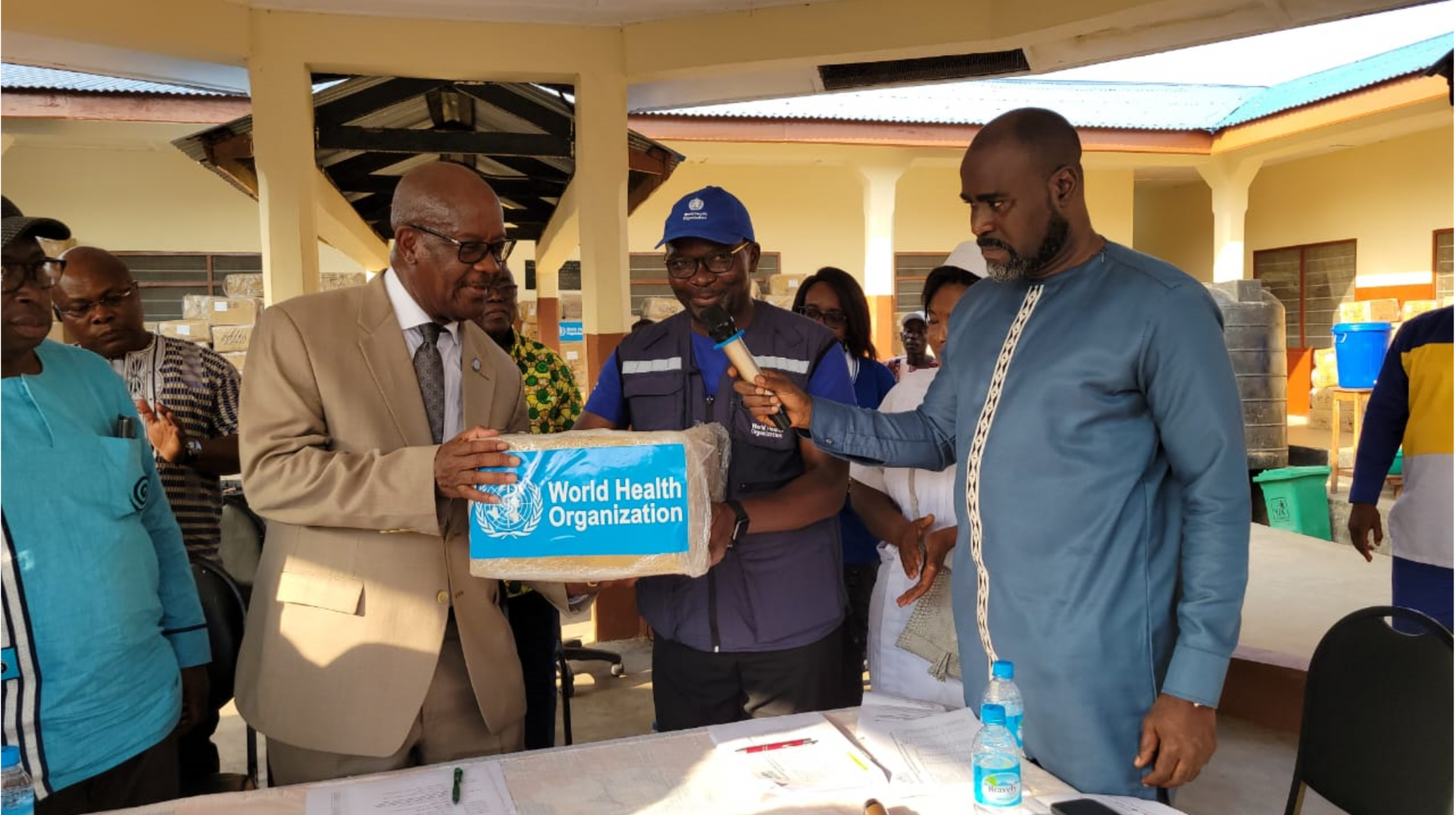 WHO Representative (left) making the symbolic handing over of the consignment to the Minister of Health and Sanitation