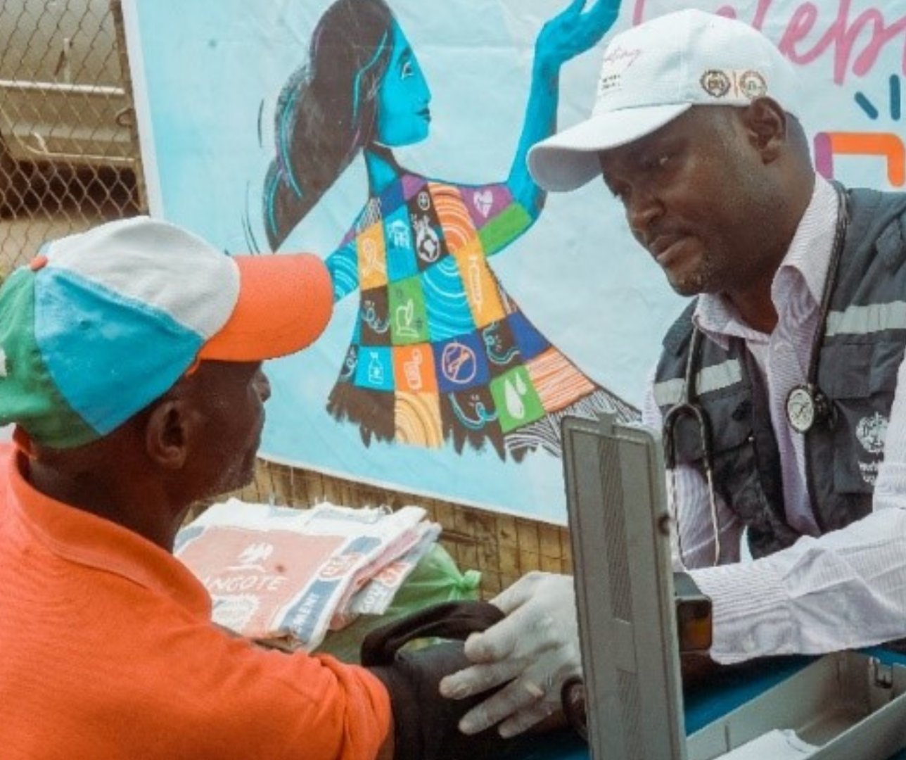 A staff checking blood pressure of a beneficary at the WHO at 75 free medical outreach in Osogbo