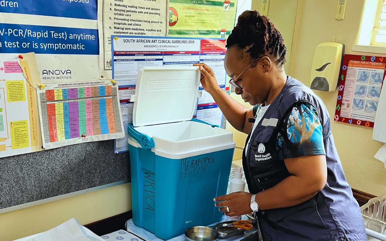 Dr Simangele Mthethwa, WHO South Africa NPO (VPD Surveillance) captured during the 2023 measles vaccination campaign, symbolizing determination and responsibility as she inspects vaccines at a vaccination center. Her earnest expression reflects a commitment to eliminating measles in South Africa.