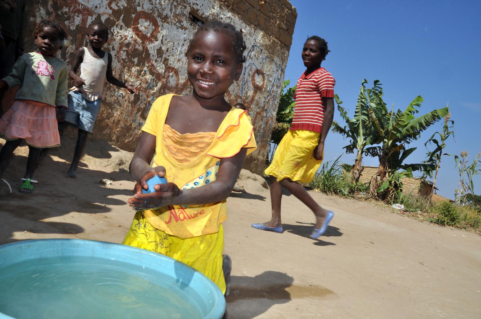 Child practicing washing hand.