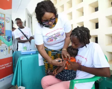 Health Minister Dr. Louise Kpoto administers the first Malaria Vaccine 