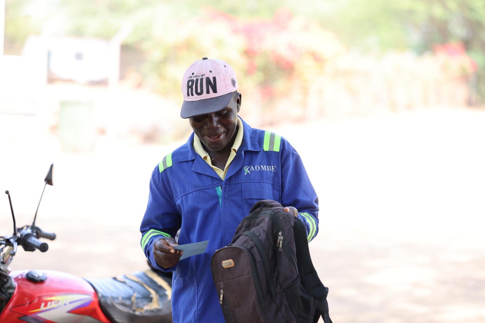 Kajobe smiles as he recieves his vaccine certificate