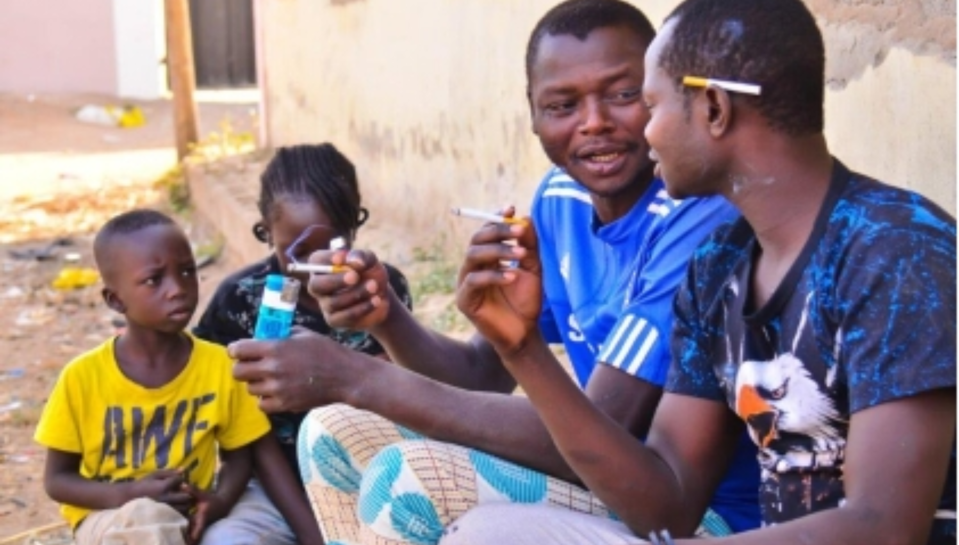 Two Adults smoking in the presence of children.