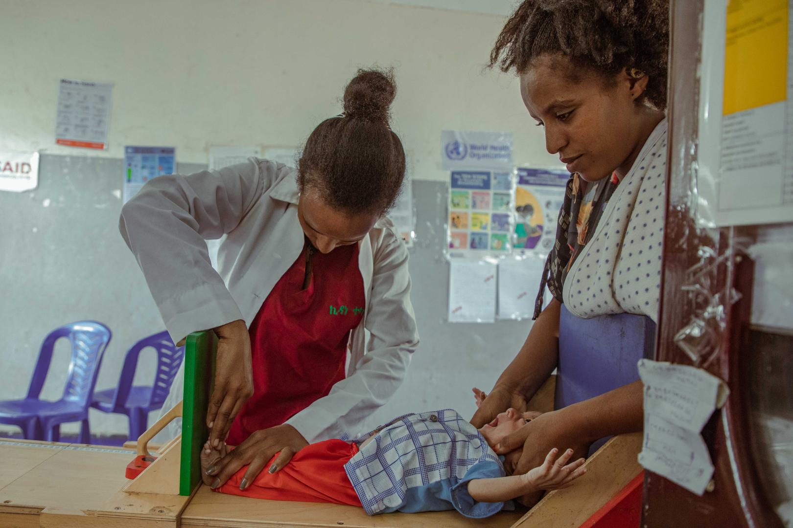 Mehonie the nurse updating the board with the newly admitted child's condition at the Stabilization Center (SC) to facilitate ongoing monitoring of the child's progress.