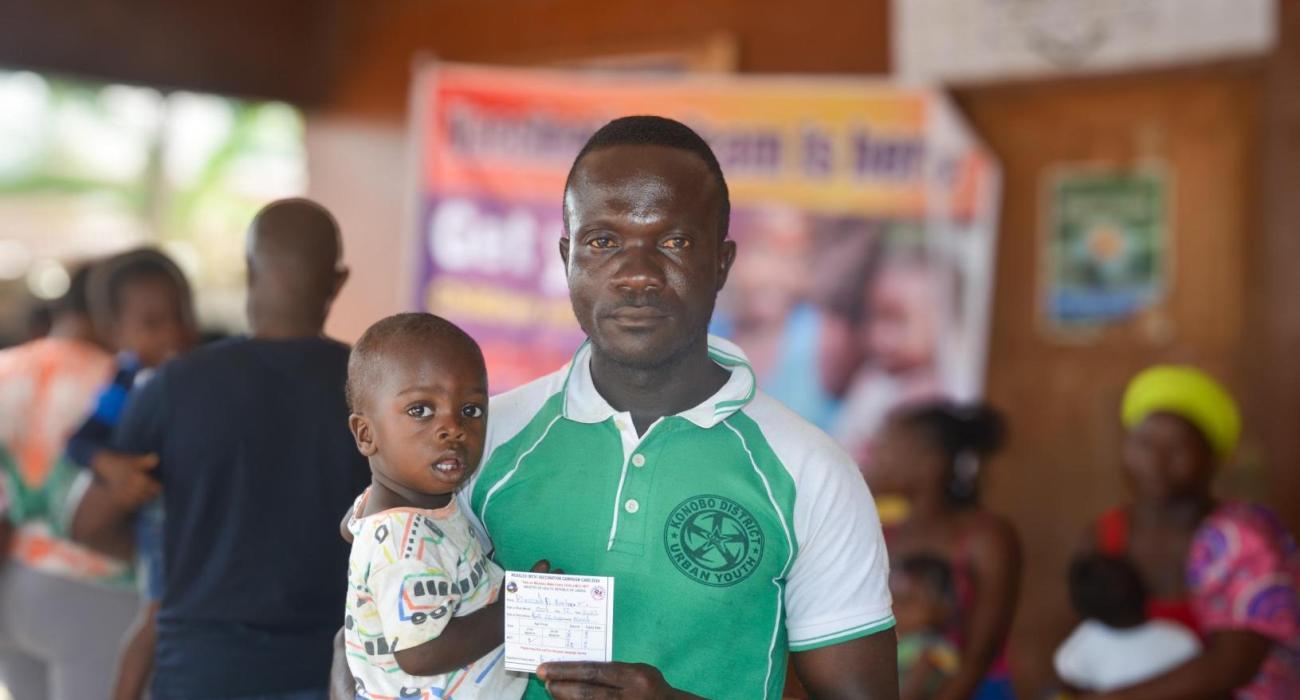 Shedrick Barlee, with his one-year-old son Blessed Barlee, at the vaccination campaign