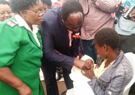 Dr Okello administering vaccine at launch