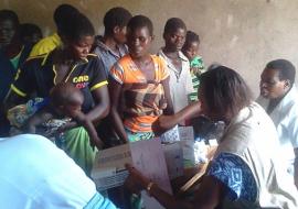 WHO Emergency Response Team member dispensing drugs at a mobile clinic WHO/H. Kubwalo