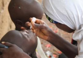 Vaccinator drops oral polio vaccine into the mouth of eligible child - Igabi LGA