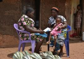 A community resource person assessing a sick child in Abia