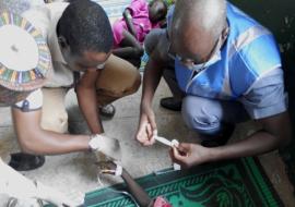 WHO staff treating a case at a temporary isolation camp in Maiduguri