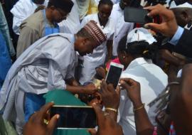 Taraba Deputy Governor Alhaji Haruna Manu immunizing a child at the flag off ceremony in Jalingo while the Minister of State for Health looks on