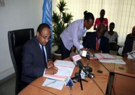 The WHO Representative, Dr. Rufaro Chatora and the Minister for Health and Social Welfare, Hon.Dr Hussein Ali Mwinyi signing certificates of transfer