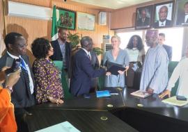 Permanent Secretary Ministry of Foreign Affairs Ambassdor Bulus Lolo exchanging signed documents with German KfW representative Dr Marga Kowalewski while WR representative Dr Rex Mapzanje (on the left) looks on