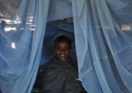 Boy sits under insecticide-treated bed net in Wonchit kebele, Dera Woreda, Amhara Region.