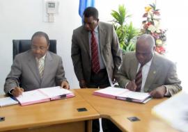 The WHO Representative, Dr. Rufaro Chatora and the Minister for Health and Social Welfare, Hon.Dr Hussein Ali Mwinyi signing certificates of transfer