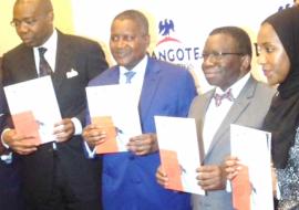 L-R Alhaji Aliko Dangote Professor Isaac Adewole and Halima Dangote during unveiling of the document