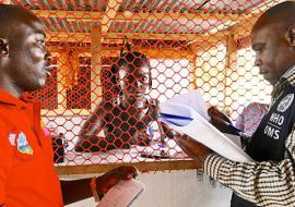 Liberia: Mr Tamba Alpha, surveillance officer, is inspecting isolation rooms at a Voinjama checkpoint with Mr Charles Ntege, WHO county coordinator. WHO/M. Winkler