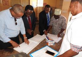 Dr Kamwa reviewing Chumbuni CTC patient records with the CTC staff