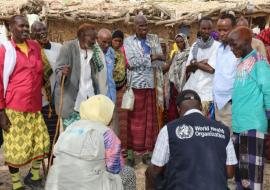 The Risk Communication Team in a discussion with a group of men in the affected community