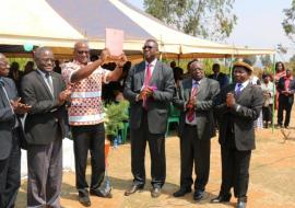 The Minister of Health, Honorable Atupele Muluzi waves high the newly launched National Alcohol Policy for Malawi