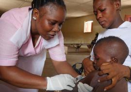 A nurse vaccinating a child