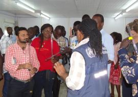 Mr Freeman showing the participants on how to use water turbidity tube for measuring the clarity of water