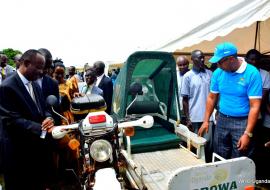 Dr Henry Mwebesa (left) and Dr Yonas (right in blue shirt) view a an ambulance that is used locally to transport patients to health centers in Luweero district