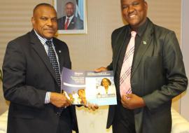 Hon Dr Alfred Madigele, new Minister of Health and Wellness (left) receiving documents from Dr M Ovberedjo, WHO Representative