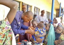 Dr Bamusa Bashir of WHO vaccinates an eligible child in Gajigana, Magumeri LGA during the ongoing measles reactive vaccination campaign in Borno state. Photo WHO