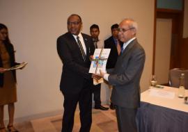 Dr Hon. Anwar Husnoo, Health Minister handing over a copy of the NHA 2017 Report to Dr Laurent Musango, WHO Representative in Mauritius