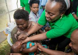 Minister of Health, Dr Diane Gashumba, administering vitamin A in the launching ceremony of MCH Week