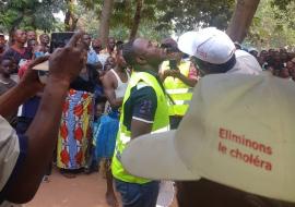 A local official receives a dose of oral cholera vaccine in Tshilenge, July 2019