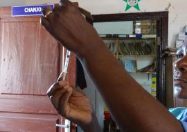 A health worker preparing a vaccine injection