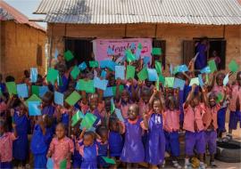 Children displaying both cards for Measles and MenA as proof of vaccination