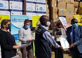 The WHO Representative, Dr.  Nathan Bakyaita handing over the donated items to the Permanent Secretary at the Ministry of Health, Dr. Kennedy Malama (right)  