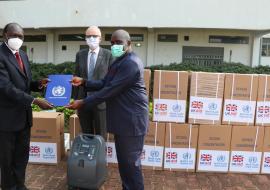 Dr Olushayo Olu, WHO Representative handing over the donation certificate to Dr Mayen Machut Achiek, Undersecretary, Ministry of Health in the presence of Chris Trott, British Ambassador